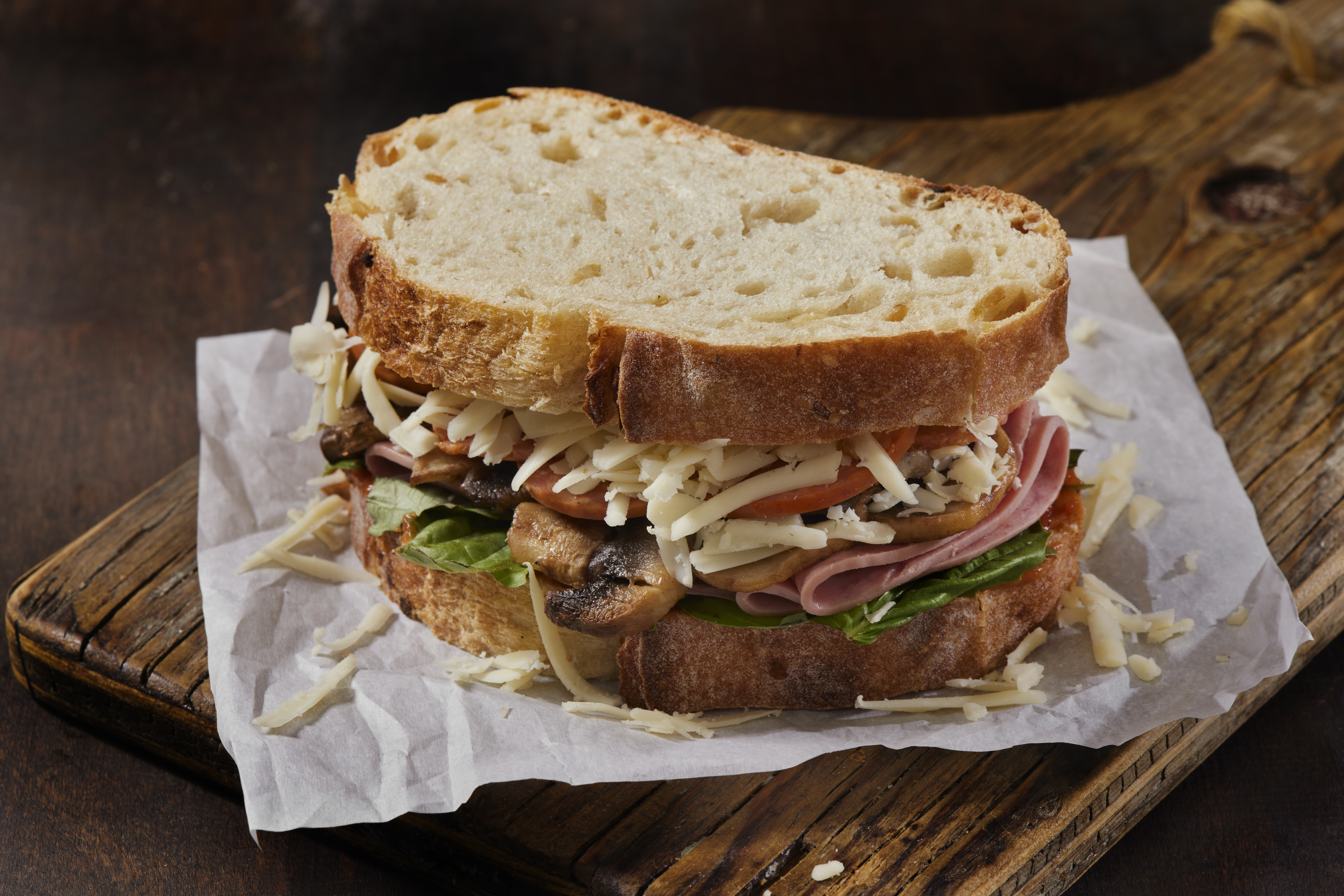 A sandwich stuffed with shredded cheese.