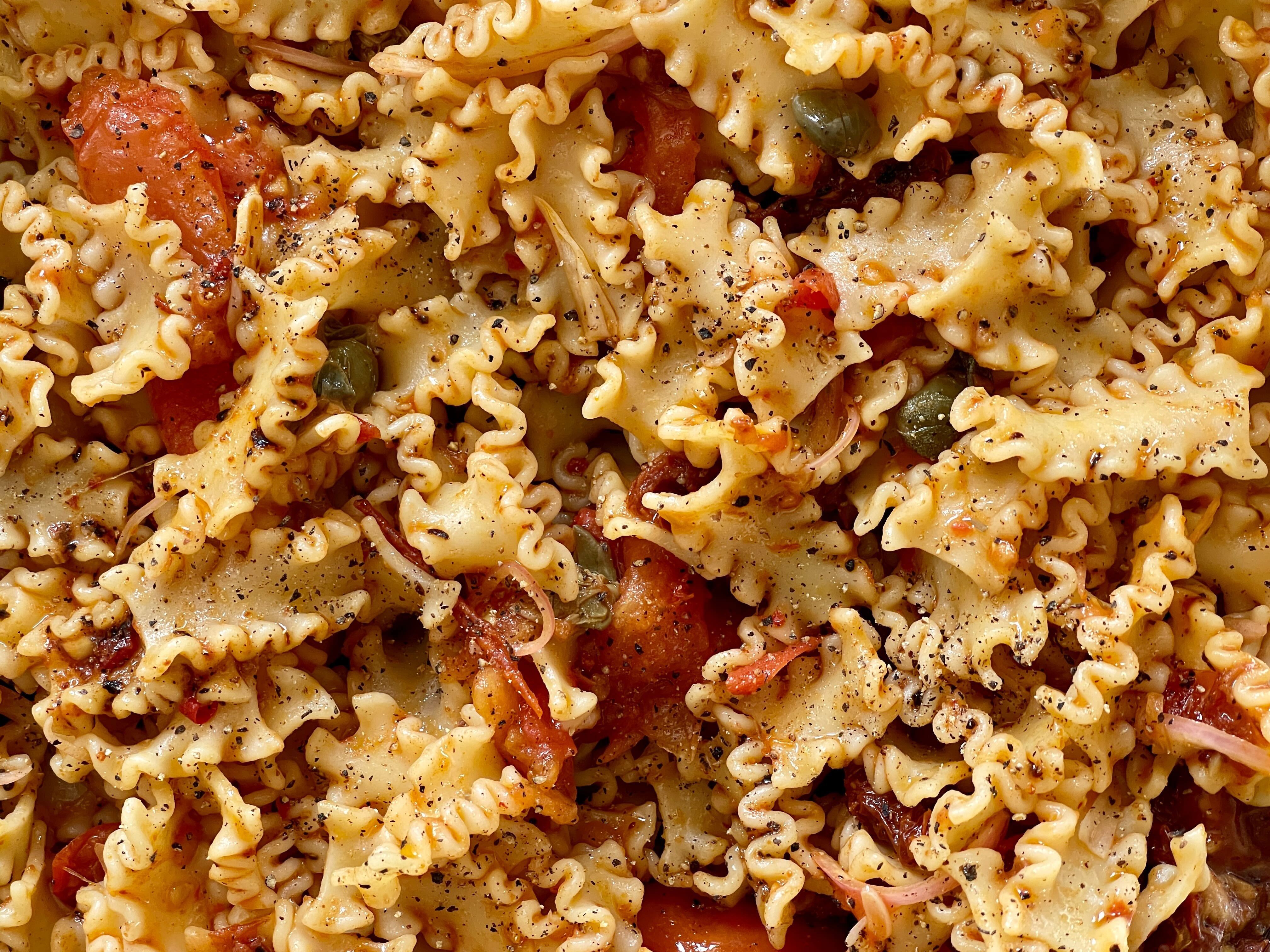 Pasta salad with tomatoes and capers.